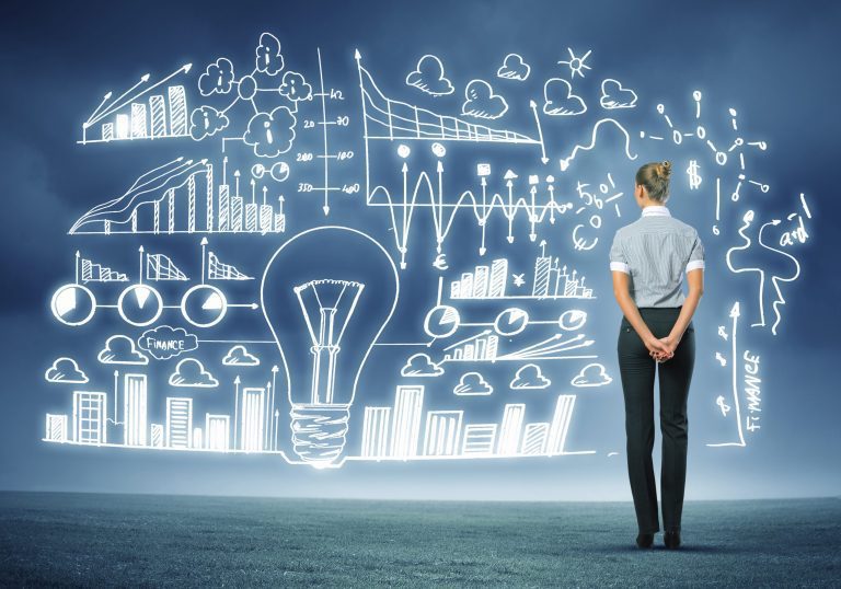 A person stands facing a large transparent screen filled with glowing business charts, graphs, and diagrams, symbolizing future-ready data analysis and strategy planning.